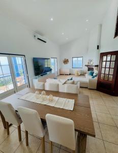 a living room with a table and a couch at Island View Retreat in Feteira