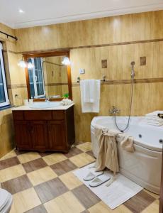 a bathroom with a tub and a sink at Island View Retreat in Feteira +21 photos