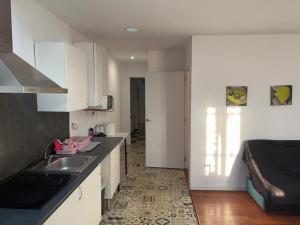 a kitchen with a sink and a counter top at Habitaciones Carmen in Rubí