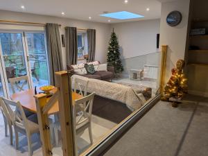 a living room with a christmas tree in a room at The Roost at The Gables Farm in Poynton
