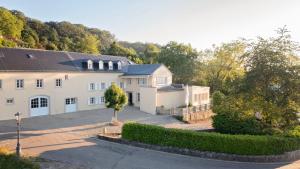 an aerial view of a white house with a driveway at Hazelnut House - Luxembourg's Secret Small Hotel in Girsterklaus