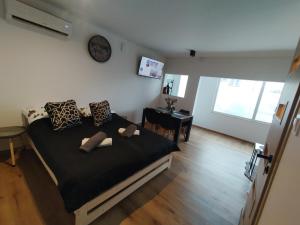 a bedroom with a bed and a clock on the wall at Mieszkanie Janowice in Janowice Wielkie