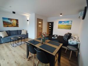 a living room with a couch and a table at Mieszkanie Janowice in Janowice Wielkie