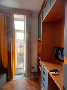 a room with a window and a desk with a computer at Parthenope b&b in Naples