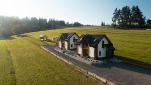 an aerial view of a house in a field at Jagodowe Domki in Ciche