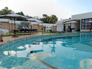 a swimming pool with blue water in a hotel at Pousada Flor de Alter in Alter do Chao