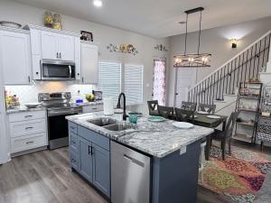 a kitchen with a sink and a counter top at Wanderlust House in Shreveport