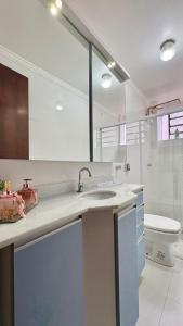 a bathroom with a sink and a toilet at 3D apartment, central - prox UFN in Santa Maria +22 photos
