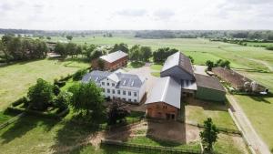 an aerial view of a large house in a field at Gut-Royum-Haferkiste in Brodersby +10 photos