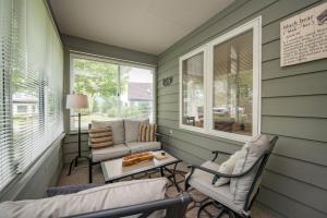 a screened in porch with chairs and a table at Cabin & Canoe by Railey Vacations in McHenry