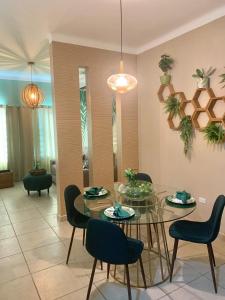 a dining room with a glass table and chairs at Casa Familiar en La Paz BCS in La Paz +22 photos