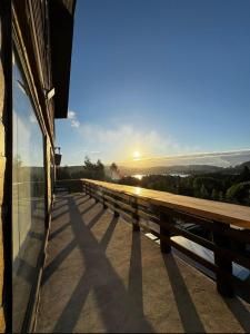a view from the balcony of a building with the sun setting at Casa Hotel Los Arrayanes in Constitución