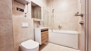 a bathroom with a toilet and a sink and a shower at CASA AL MARE by Moskva in Budva
