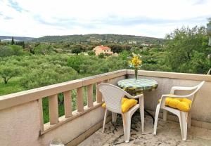 a balcony with two chairs and a table with a view at House Niksi in Škrip