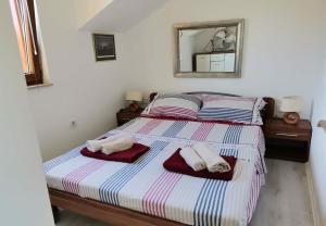 a bedroom with a bed with towels on it at House Niksi in Škrip +43 photos