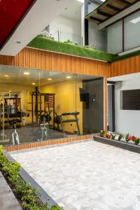 a house with a patio with a gym at Hotel Santiago de Compostella Suites in Cuenca