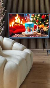 a living room with a fireplace with a christmas coffee cup at The Boutique Suite - Schaanwald in Schaanwald
