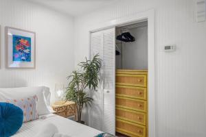 a bedroom with a bed and a closet and a dresser at Be A Nomad - Pool Access Studio Apartment - Jacksonville Beach Couples in Jacksonville Beach