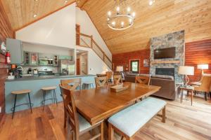 a dining room and kitchen with a wooden table and chairs at Lakefront Escape by Railey Vacations in Swanton
