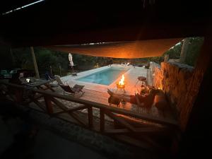 a swimming pool with a fire in front of it at Altos del Cordón in Comodoro Rivadavia +58 photos