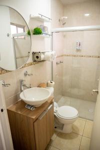 a bathroom with a sink and a toilet and a mirror at Loft Montecarlo in Hermosillo +12 photos