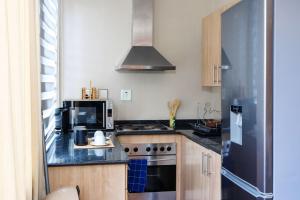 a kitchen with a stove and a microwave at The Orange Corner II in Johannesburg