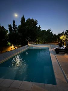 a swimming pool in a yard at night at Altos del Cordón in Comodoro Rivadavia