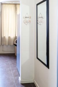a mirror on a wall next to a door at The Orange Corner II in Johannesburg +24 photos