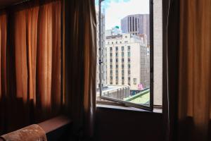 a window with a view of a city skyline at The Orange Corner II in Johannesburg