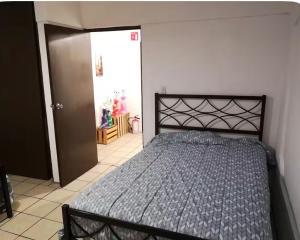 a bedroom with a bed in a room with a door at Casa del Estadio in Guadalajara