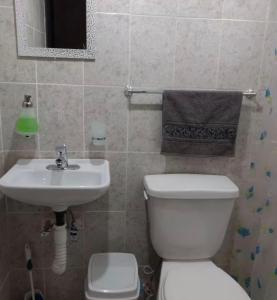 a bathroom with a white toilet and a sink at Casa del Estadio in Guadalajara