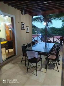 a dining room with a table and chairs on a patio at Guaramiranga-ce Chalé do Rei in Guaramiranga