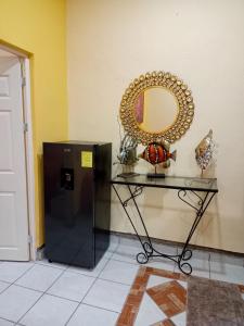 a mirror on a wall next to a table at Casa Amelia in San Blas