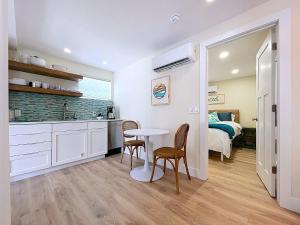 a kitchen and dining room with a table and chairs at Get Seaduced by this 1 bed 1 bath charmer steps to beach and Bridge St in Bradenton Beach