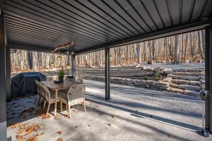 a screened in porch with a table and chairs at Casa Olive by Railey Vacations in Accident