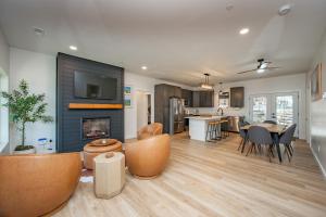 a living room with a fireplace and a dining room at Casa Olive by Railey Vacations in Accident