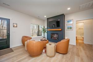 a living room with chairs and a fireplace at Casa Olive by Railey Vacations in Accident +61 photos