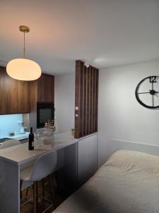 a bedroom with a bed and a table and a clock at Sky Nest Kopaonik in Kopaonik