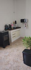 a kitchen with a black stove and a counter at Bem te vi in Niterói