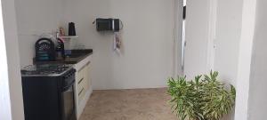 a kitchen with a black stove and a sink at Bem te vi in Niterói +3 photos