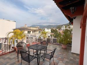 un patio con tavolo e sedie su un balcone di Hotel Mocali a Puerto Vallarta Altre 26 foto