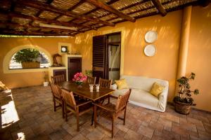 a living room with a table and a couch at Resort Al Belvedere Salina in Leni