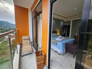 a hotel room with a bed and a balcony at Hotel Kiara in Cataltzul