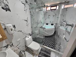 a bathroom with a toilet and a sink at Hotel Kiara in Cataltzul
