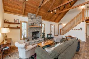 a living room with couches and a fireplace at Lighthearted Lodge by Railey Vacations in Swanton