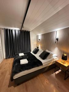a bedroom with a large bed and a table at Northern lights Ivalo Stay in Ivalo