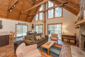 a living room with a couch and a fireplace at Lighthearted Lodge by Railey Vacations in Swanton +46 photos