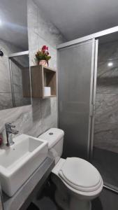 a bathroom with a white toilet and a sink at mini departamento Andahuaylas in Andahuaylas