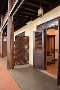an entrance to a building with a wooden door at Colonial House Mekong River View in Luang Prabang +6 photos