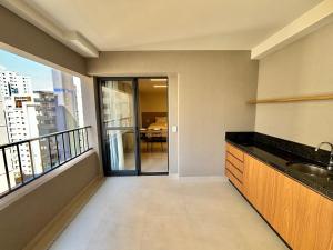 a kitchen with a sink and a balcony at Apart St Bueno SuperKing Ar, Cozinha, Vaga in Goiânia